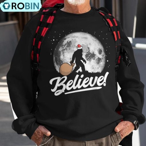 Believe Santa Bigfoot Christmas Snow & Moon Night Graphic Ugly Christmas Sweatshirt
